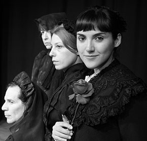 Maria Toledo in a black and white period costume scene